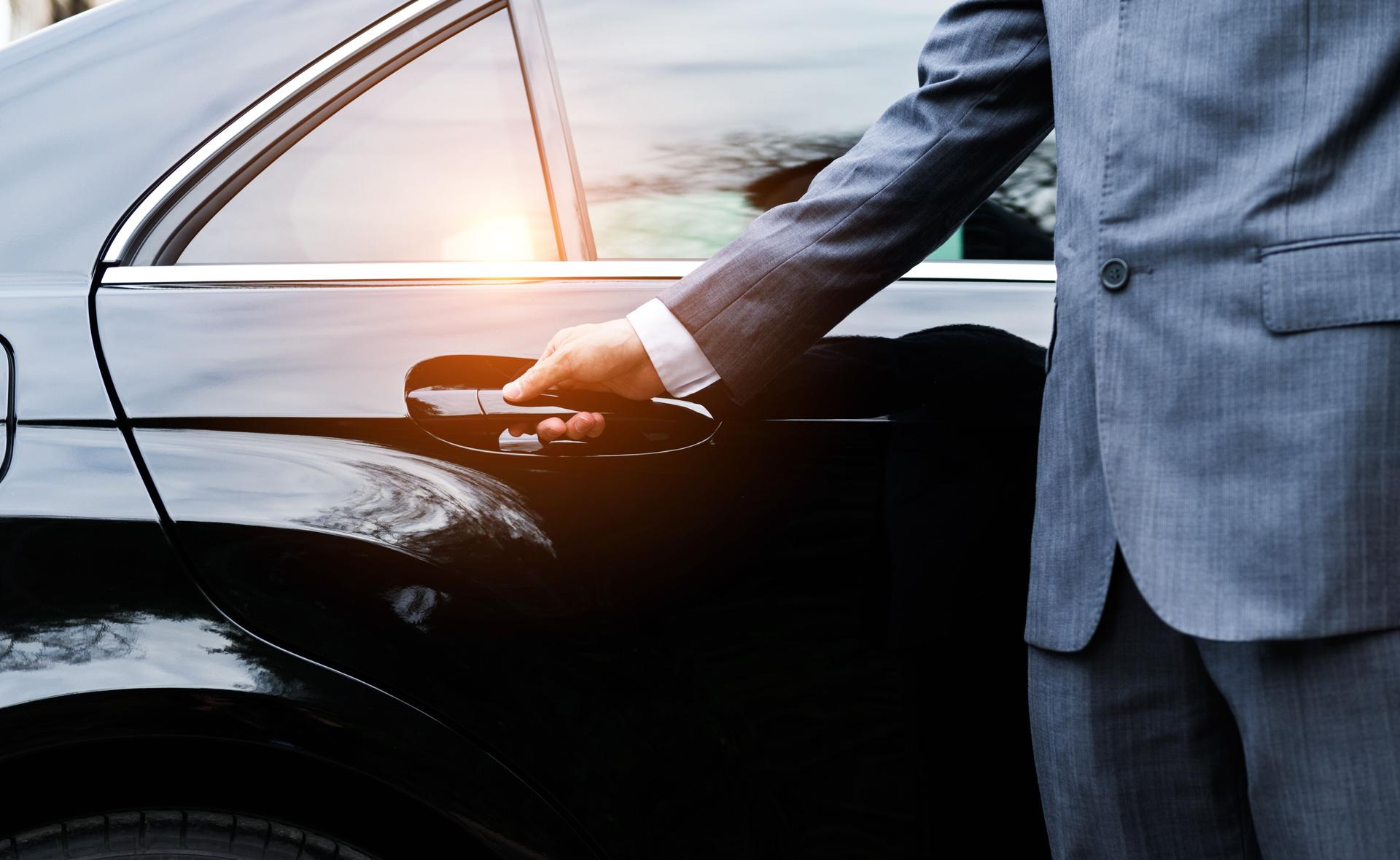 Closeup of a doormans opening a car door