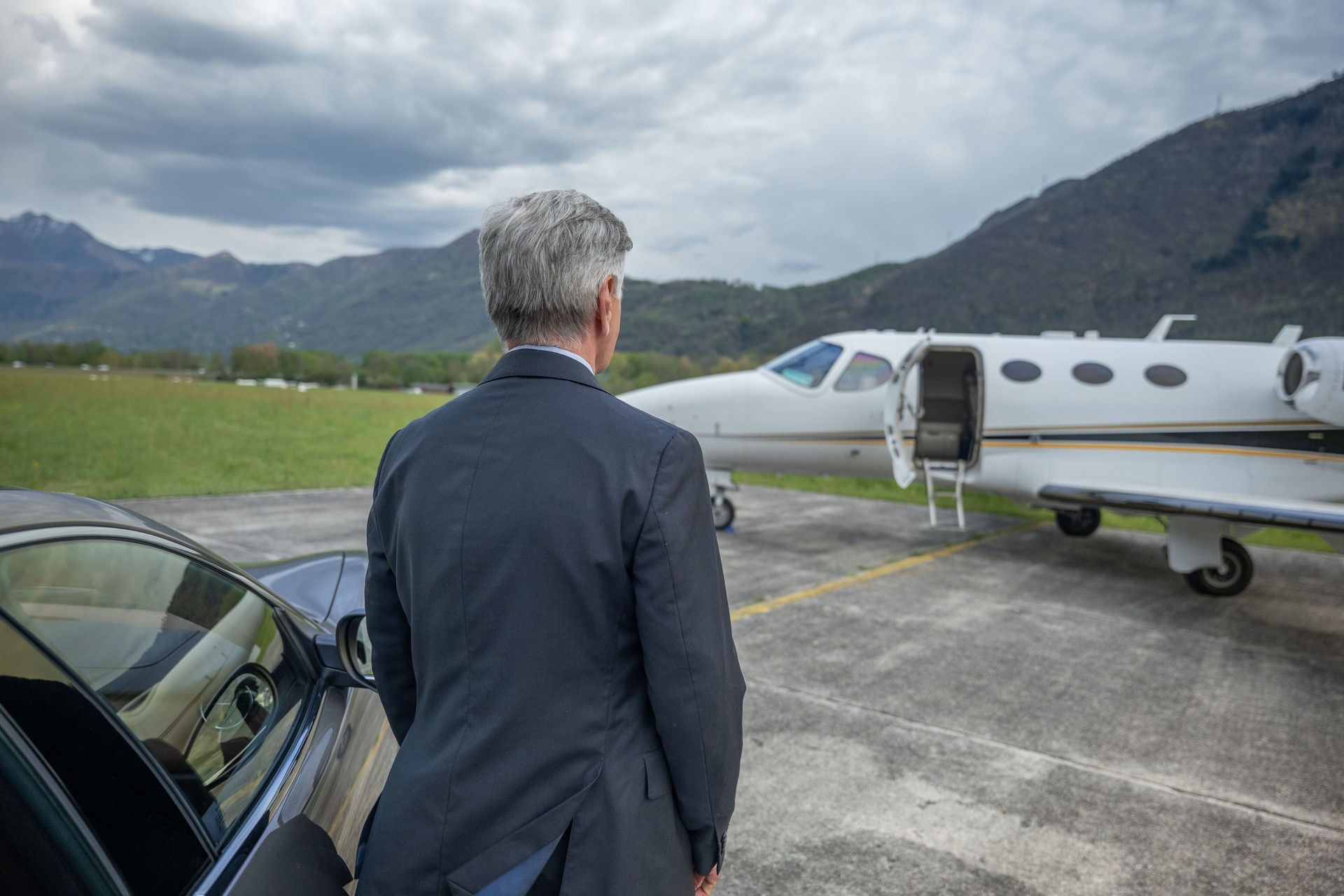 Chauffeur standing by private airplane